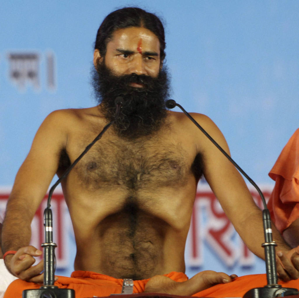 Renowned yoga guru Baba Ramdev performs Yoga exercises before going on a hunger strike with his followers in New Delhi, India, Saturday, June 4, 2011. Ramdev along with tens of thousands of his followers started an indefinite hunger strike in the Indian capital to protest against corruption and what he says is the Indian government's inaction in bringing back black money stashed abroad. (AP Photo)