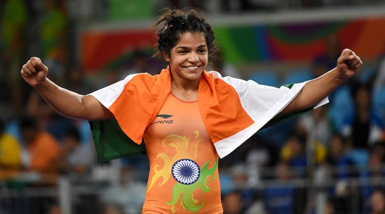 India's Sakshi Malik waves national flag