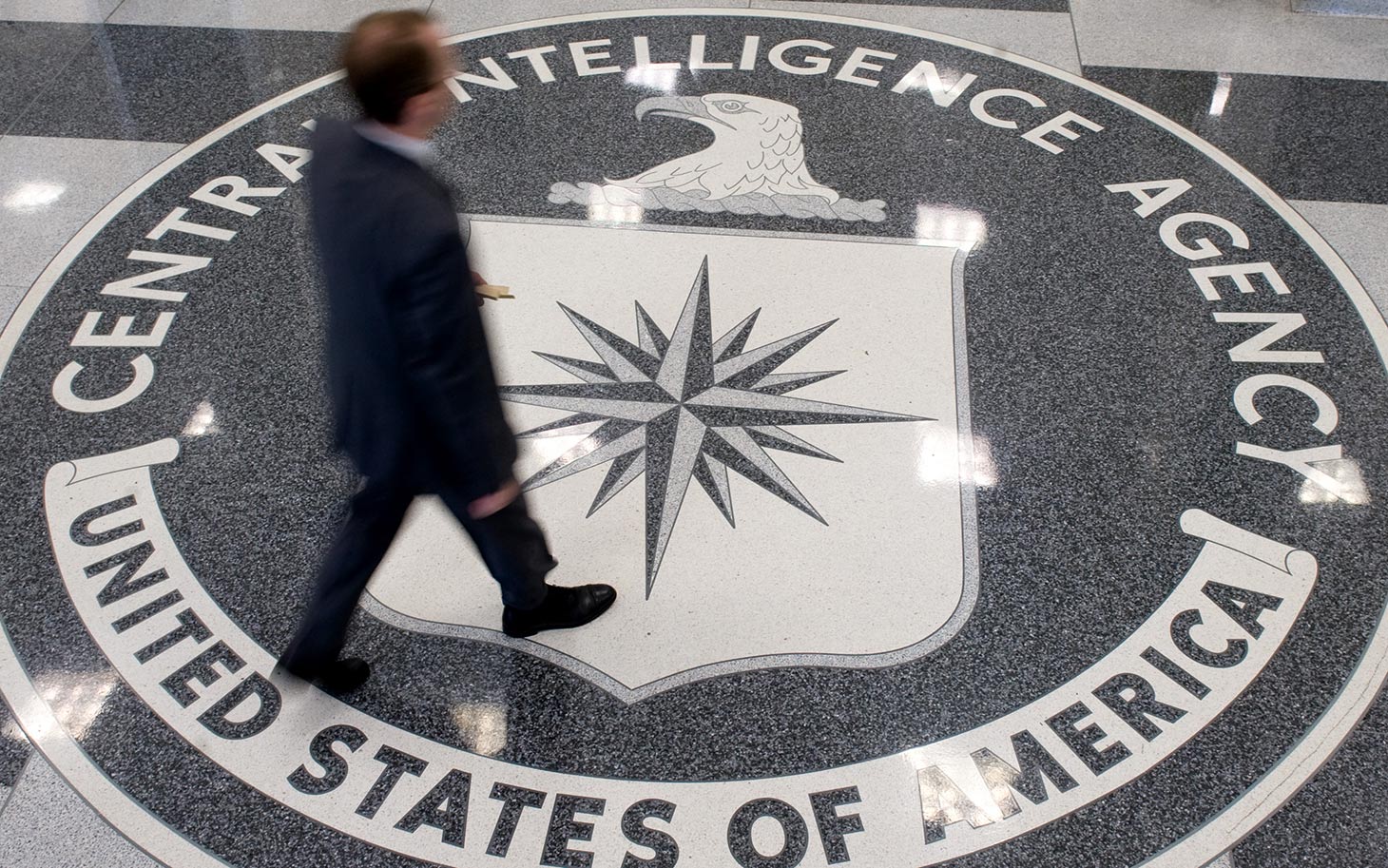 A man crosses the Central Intelligence Agency (CIA) logo in the lobby of CIA Headquarters in Langley, Virginia, on August 14, 2008. AFP PHOTO/SAUL LOEB (Photo credit should read SAUL LOEB/AFP/Getty Images)